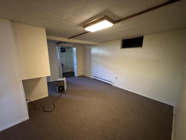 201 Broadway St, Rollingstone, MN 55969 - finished basement featuring a baseboard heating unit, dark colored carpet, and baseboards