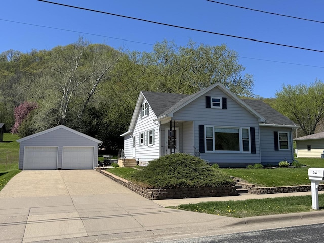 201 Broadway St, Rollingstone, MN 55969 - bungalow-style home with an outdoor structure, a garage, a front yard, and roof with shingles