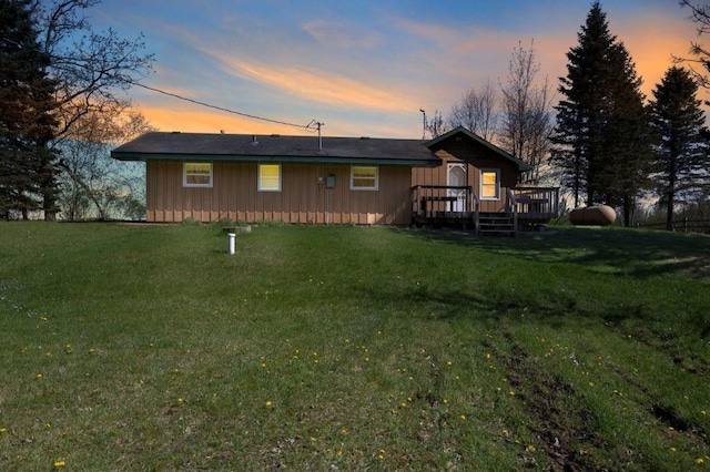 23920 Camp Rd, Siren, WI 54872 - rear view of property with board and batten siding, a deck, and a lawn
