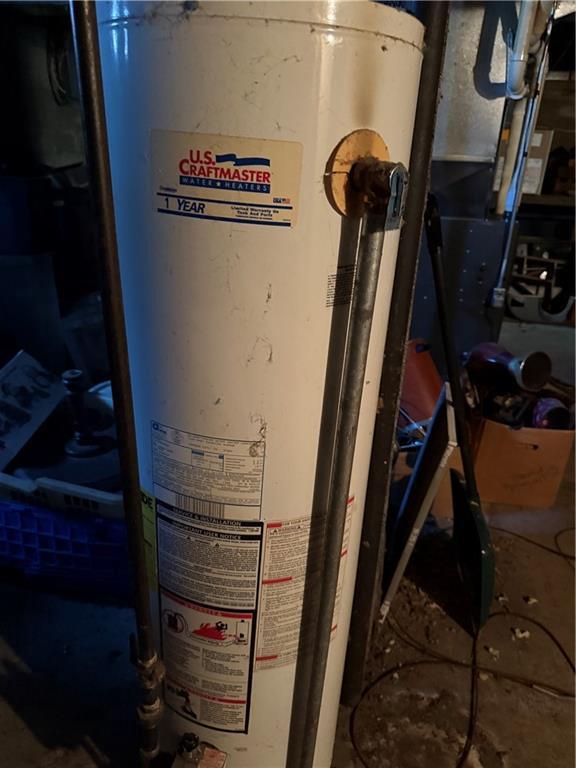 utility room with gas water heater