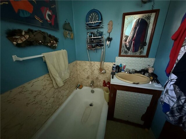 full bath featuring vanity and a bath