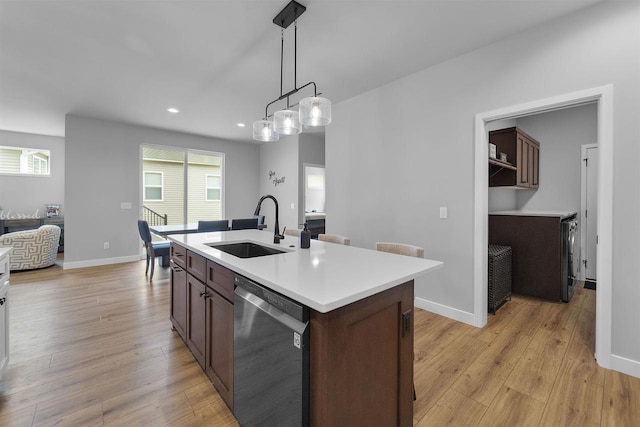 2149 Rosenberg Ln, Sun Prairie, WI 53590 - kitchen featuring dishwasher, a sink, light countertops, light wood finished floors, and recessed lighting