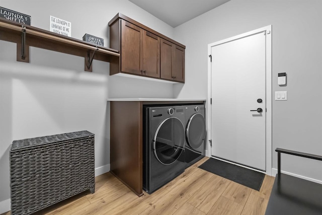 2149 Rosenberg Ln, Sun Prairie, WI 53590 - clothes washing area with washing machine and dryer, cabinet space, and light wood-style floors