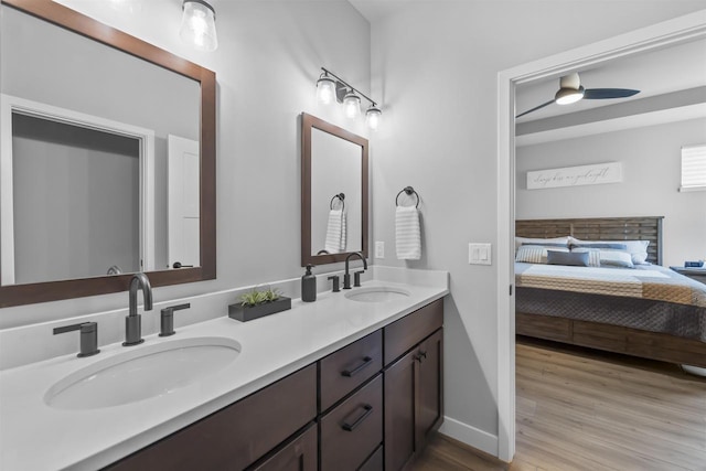 2149 Rosenberg Ln, Sun Prairie, WI 53590 - ensuite bathroom with wood finished floors, double vanity, a ceiling fan, and baseboards