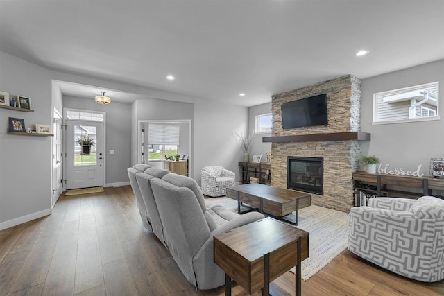 2149 Rosenberg Ln, Sun Prairie, WI 53590 - living area featuring a fireplace, plenty of natural light, recessed lighting, wood finished floors, and baseboards