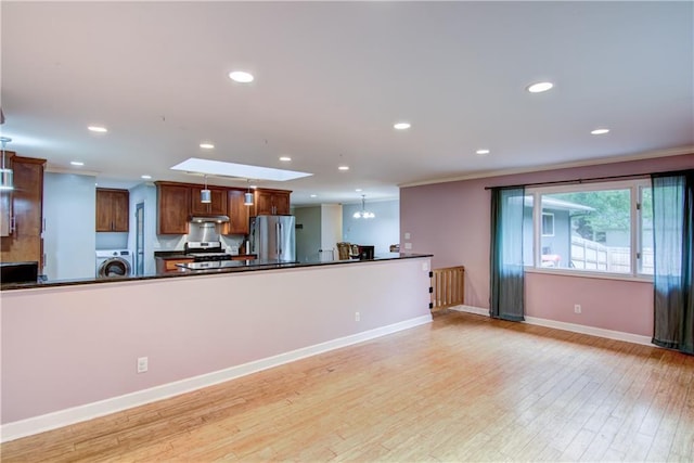 19333 59th Ave, Chippewa Falls, WI 54729 - kitchen with appliances with stainless steel finishes, washer / dryer, dark countertops, ornamental molding, and recessed lighting