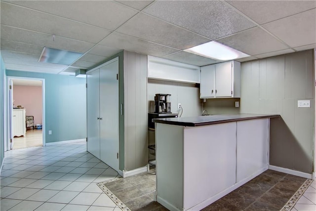 19333 59th Ave, Chippewa Falls, WI 54729 - kitchen featuring a drop ceiling, white cabinetry, light tile patterned floors, a peninsula, and baseboards