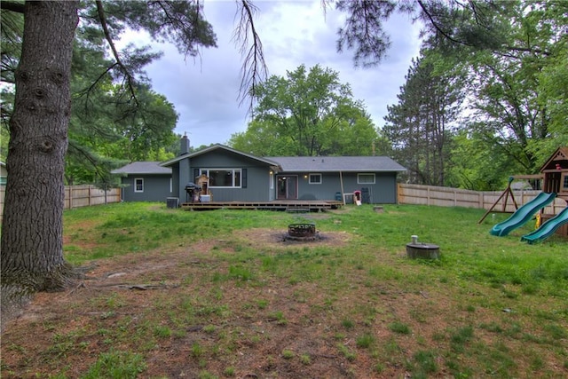 19333 59th Ave, Chippewa Falls, WI 54729 - rear view of house featuring a fire pit, a playground, a deck, and a chimney