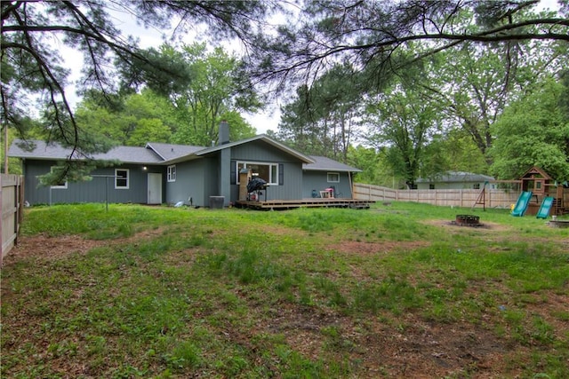 19333 59th Ave, Chippewa Falls, WI 54729 - rear view of house with a fire pit, a playground, a chimney, a deck, and central AC unit