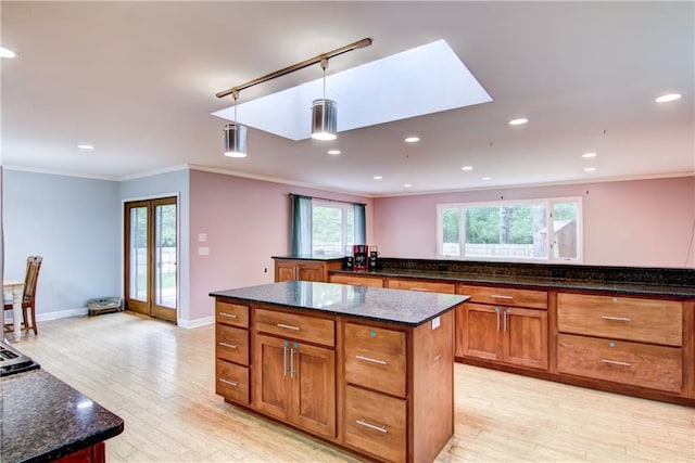 19333 59th Ave, Chippewa Falls, WI 54729 - kitchen featuring a center island, crown molding, light wood-style flooring, hanging light fixtures, and brown cabinetry