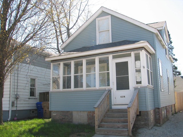 4314 Sheridan Rd, Kenosha, WI 53140 - view of front facade with a shingled roof and a sunroom