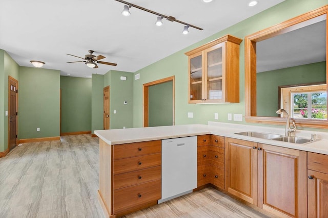 2210 Alban Ln, Prairie Du Sac, WI 53578 - kitchen featuring white dishwasher, a peninsula, a sink, light wood-style floors, and ceiling fan