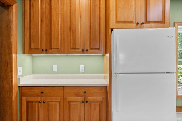 2210 Alban Ln, Prairie Du Sac, WI 53578 - kitchen with freestanding refrigerator, light countertops, and brown cabinetry