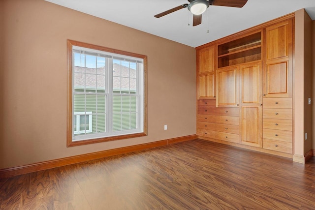 2210 Alban Ln, Prairie Du Sac, WI 53578 - unfurnished bedroom with baseboards, dark wood-type flooring, and a ceiling fan