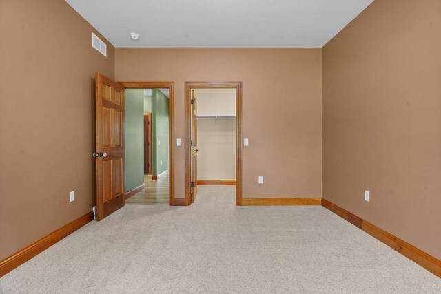2210 Alban Ln, Prairie Du Sac, WI 53578 - unfurnished bedroom featuring light carpet, baseboards, a spacious closet, and a closet