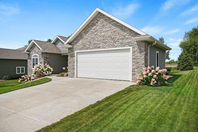2210 Alban Ln, Prairie Du Sac, WI 53578 - view of front of property with stone siding, concrete driveway, an attached garage, and a front lawn