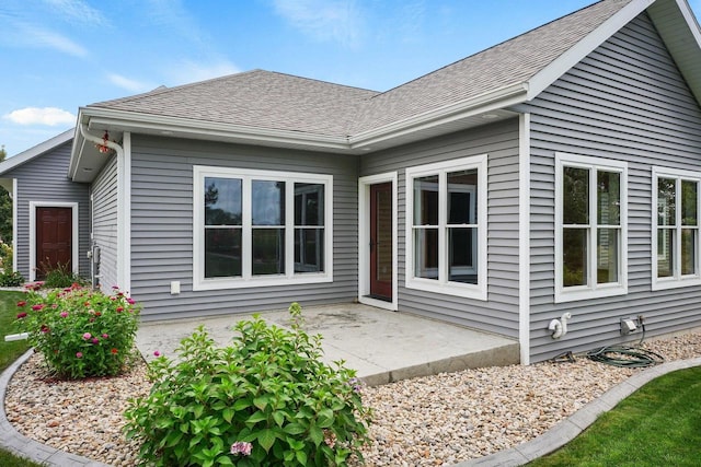 2210 Alban Ln, Prairie Du Sac, WI 53578 - rear view of house with a shingled roof and a patio