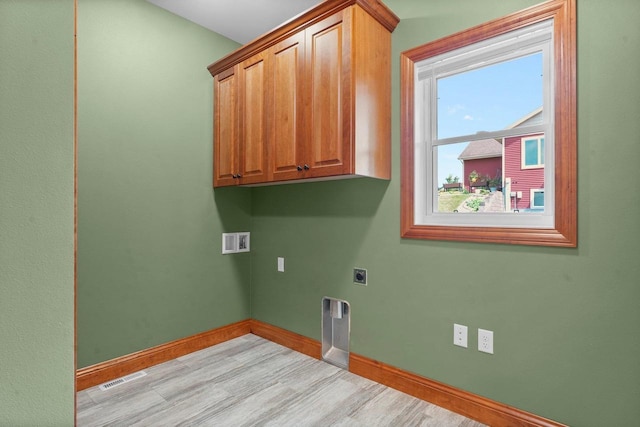 2210 Alban Ln, Prairie Du Sac, WI 53578 - clothes washing area with electric dryer hookup, baseboards, cabinet space, and light wood-style floors