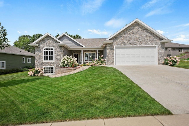 2210 Alban Ln, Prairie Du Sac, WI 53578 - view of front of house with stone siding, an attached garage, a front yard, and concrete driveway