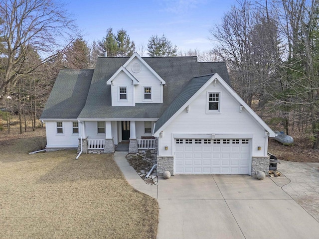 1229 Riverwood Ln, Sobieski, WI 02413 - view of front of home featuring covered porch, driveway, stone siding, and a shingled roof