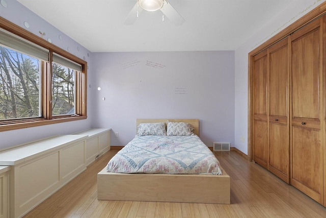 1229 Riverwood Ln, Sobieski, WI 02413 - bedroom with light wood-style floors, a closet, and ceiling fan