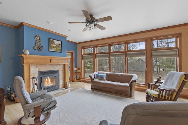 1229 Riverwood Ln, Sobieski, WI 02413 - living area featuring a tile fireplace, light wood finished floors, a ceiling fan, ornamental molding, and recessed lighting
