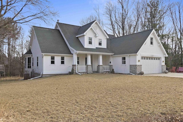 1229 Riverwood Ln, Sobieski, WI 02413 - view of front of property featuring covered porch, concrete driveway, stone siding, a shingled roof, and a garage