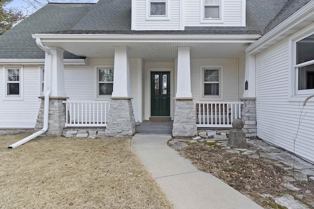 1229 Riverwood Ln, Sobieski, WI 02413 - entrance to property featuring a porch, a shingled roof, and stone siding