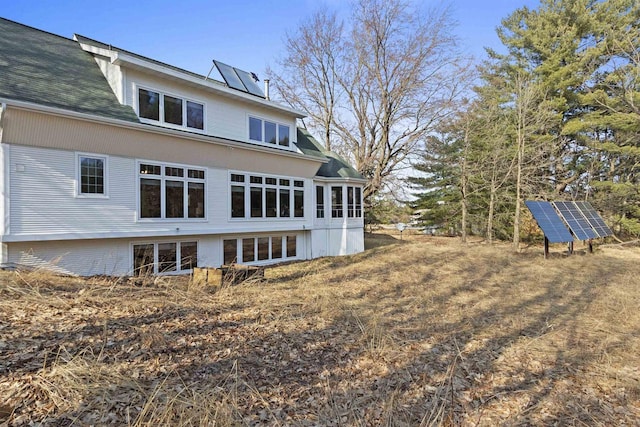 1229 Riverwood Ln, Sobieski, WI 02413 - back of property featuring ground mounted solar panels and a shingled roof