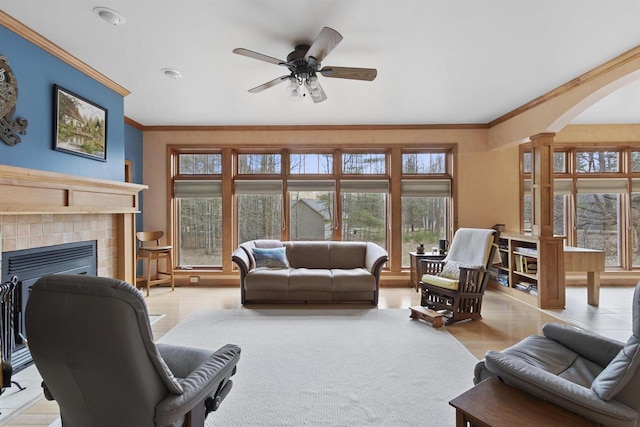 1229 Riverwood Ln, Sobieski, WI 02413 - living room featuring arched walkways, crown molding, plenty of natural light, a fireplace, and a ceiling fan