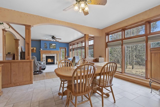 1229 Riverwood Ln, Sobieski, WI 02413 - dining area with ceiling fan, decorative columns, a glass covered fireplace, and arched walkways