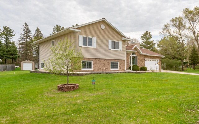 N2664 Grand Path, Wautoma, WI 54982 - tri-level home with concrete driveway, a front yard, a garage, and brick siding