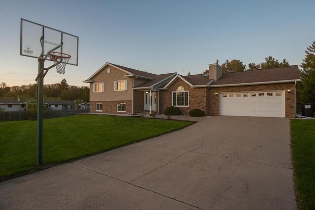 N2664 Grand Path, Wautoma, WI 54982 - tri-level home featuring brick siding, driveway, and an attached garage