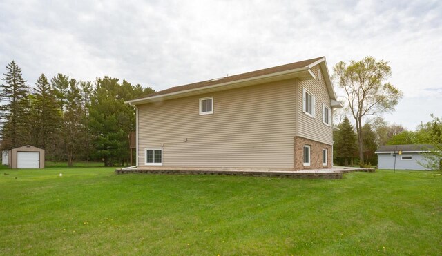 N2664 Grand Path, Wautoma, WI 54982 - rear view of house with a garage, an outdoor structure, and a yard