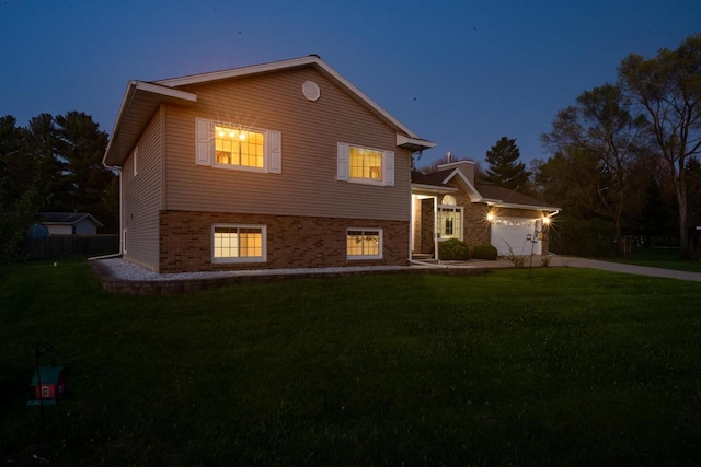 N2664 Grand Path, Wautoma, WI 54982 - tri-level home with an attached garage, a front lawn, driveway, and brick siding
