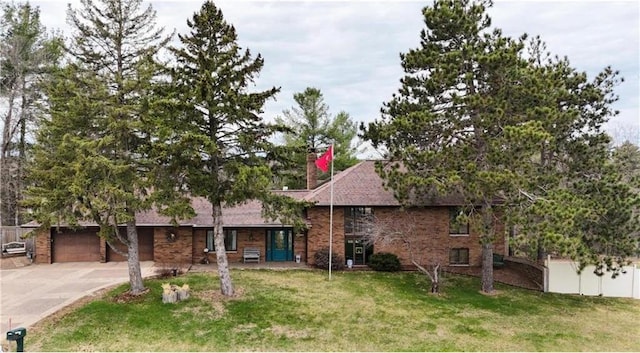 single story home with driveway, a chimney, and brick siding