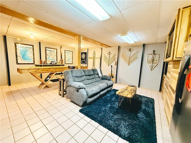tiled living area with a drop ceiling