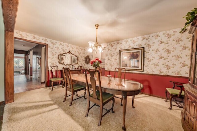 15555 Esser Ct, Brookfield, WI 53005 - dining space with a wainscoted wall, carpet floors, wallpapered walls, and a chandelier