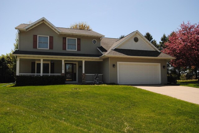 1116 Redwood Ct, Delavan, WI 53115 - view of front of home with a garage, a front yard, covered porch, and concrete driveway