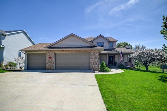 717 Larvik Ln, Stoughton, WI 53589 - view of front facade with an attached garage, a front lawn, concrete driveway, brick siding, and covered porch