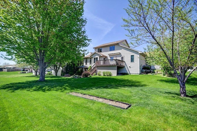 717 Larvik Ln, Stoughton, WI 53589 - rear view of house featuring stairway, a deck, and a lawn
