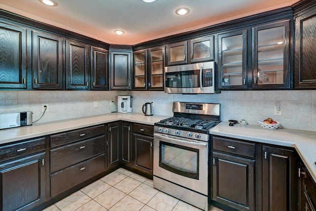 717 Larvik Ln, Stoughton, WI 53589 - kitchen with stainless steel appliances, light tile patterned floors, backsplash, light countertops, and recessed lighting