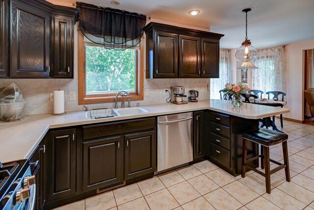717 Larvik Ln, Stoughton, WI 53589 - kitchen featuring stainless steel appliances, a sink, light countertops, tasteful backsplash, and recessed lighting