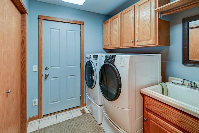 717 Larvik Ln, Stoughton, WI 53589 - laundry area featuring cabinet space, separate washer and dryer, light tile patterned floors, and baseboards