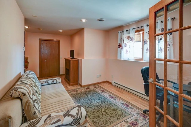 717 Larvik Ln, Stoughton, WI 53589 - living room featuring wood finished floors, baseboard heating, recessed lighting, and baseboards