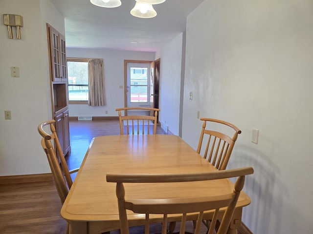 705 W Taylor St, Plainfield, WI 54966 - dining space with dark wood-type flooring and baseboards