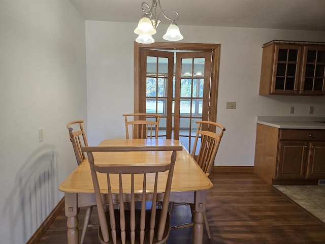 705 W Taylor St, Plainfield, WI 54966 - dining space featuring baseboards, dark wood-type flooring, and a chandelier