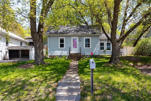 bungalow-style home featuring a garage and entry steps