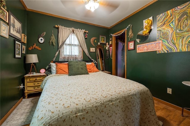 bedroom with ornamental molding, baseboards, a ceiling fan, wood finished floors, and a closet