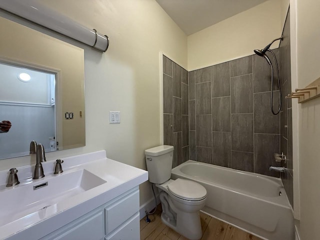 613 Vaughn Ave, Ashland, WI 54806 - full bathroom with toilet, wood finished floors, vanity, and tub / shower combination